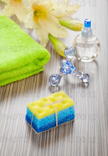 Bath objects and flower on a wooden background