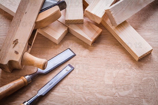 Chisel Woodworker Plane and planks on wooden board