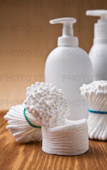 Cotton buds and pads on a wooden board