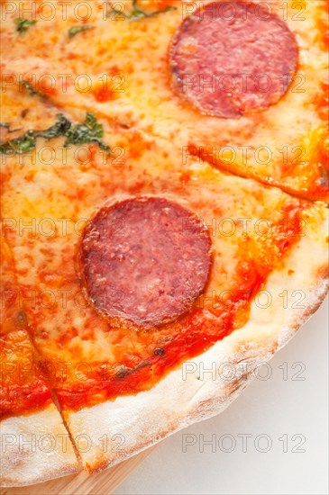 Italian original thin crust pepperoni pizza extrene close up