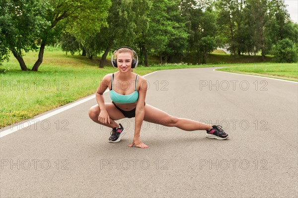 Charming girl does a workout in the park. The concept of a healthy lifestyle. Sports Equipment. Fitness style advertisement. Mixed media