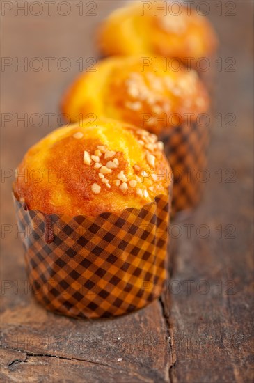 Fresh baked muffin on old wood table