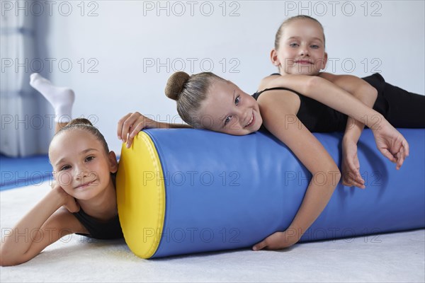 Image of a group of little girls in the gym after a workout. Gymnastics concept. Mixed media