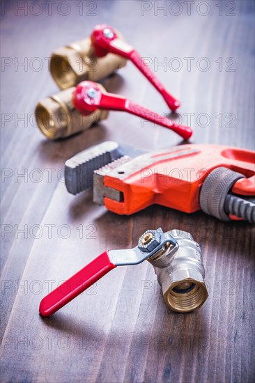 Adjustable spanner and sanitary fittings on an old wooden board