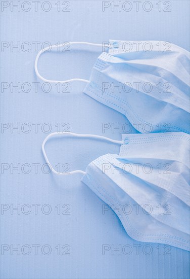 Disposable face masks on a blue background medical concept