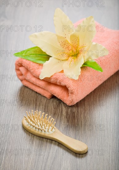 Flower on pink towel with hairbrush