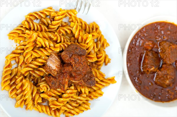 Fusilli pasta al dente with neapolitan style ragu meat sauce very different from bolognese style