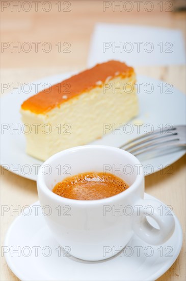 Italian espresso coffee and cheese cake over white wood table