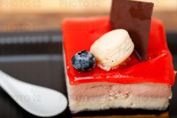 Fresh strawberry yogurt mousse with macaroon and blueberry on top