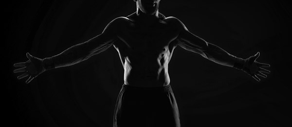 Noname image of a kickboxer on a dark background. The concept of mixed martial arts. MMA