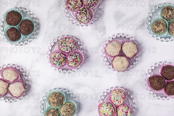 Light and dark rum balls on glass plates