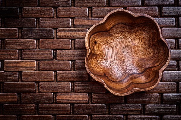 Flowershaped bowl on wooden place mat food and drink concept