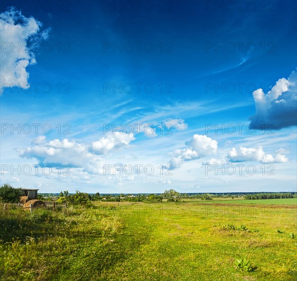 A rural vista and cloudy skies