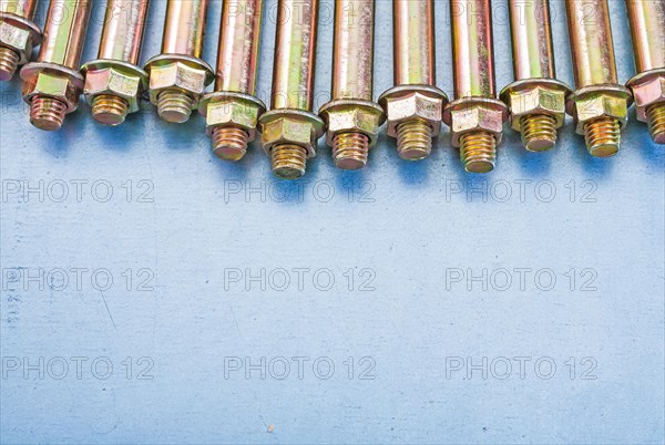 Copy space image Anchor bolts for concrete walls and nuts on metallic background Construction concept