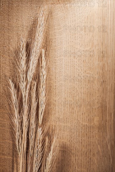 Wheat ears on oak board with copy field