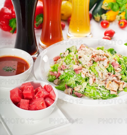 Fresh classic caesar salad with red and blonde beer on background