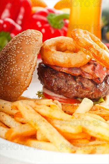 Classic american hamburger sandwich with onion rings and french fries