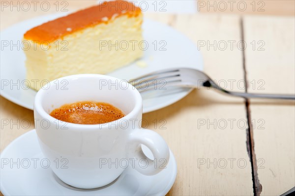 Italian espresso coffee and cheese cake over white wood table