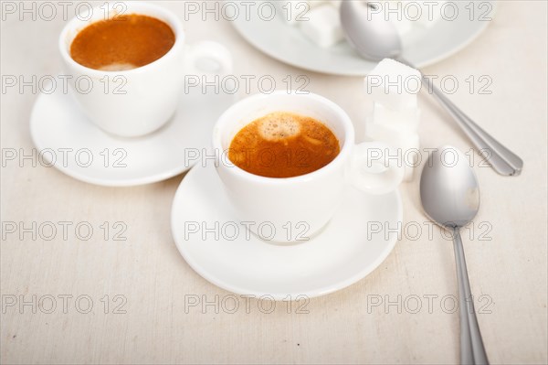 Italian espresso coffee fresh brewed macro closeup with sugar cubes