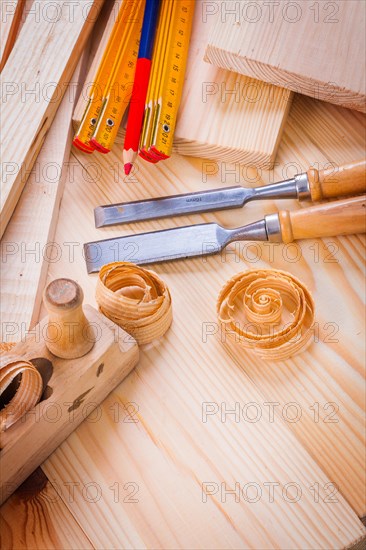 Carpentry tools wooden metre woodworkers plane chisels pencil shavings on boards