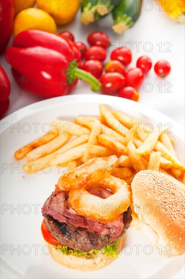 Classic american hamburger sandwich with onion rings and french fries