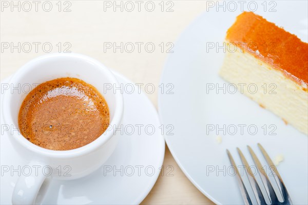 Italian espresso coffee and cheese cake over white wood table