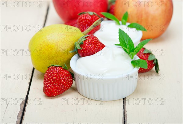 Fresh fruits and whole milk yogurt on a rustic wood table