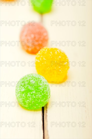 Sugar jelly fruit candy over white wood table