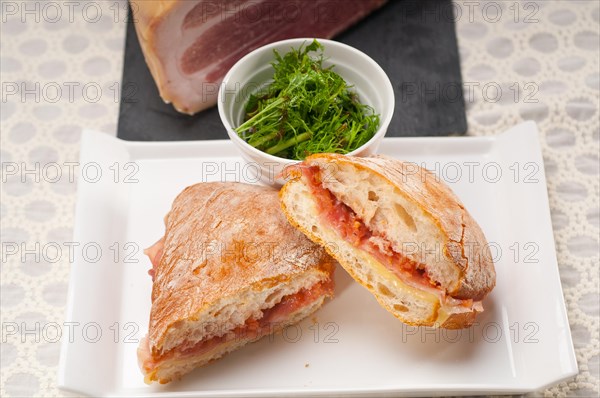 Italian ciabatta panini sandwich with parma ham and tomato