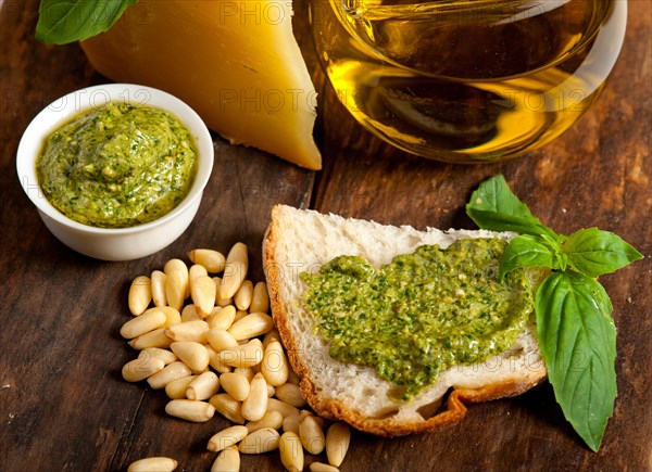 Italian basil pesto bruschetta ingredients over old wood macro