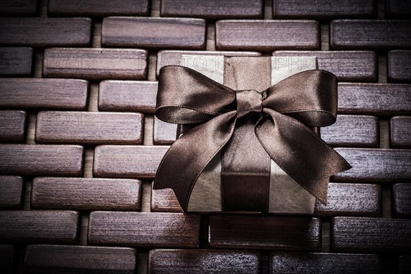 Giftbox on wooden wicker place mat holidays concept