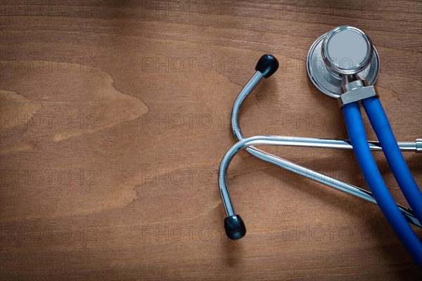 Horizontal view of stethoscope for medical examination on pine vintage wooden board medicine concept