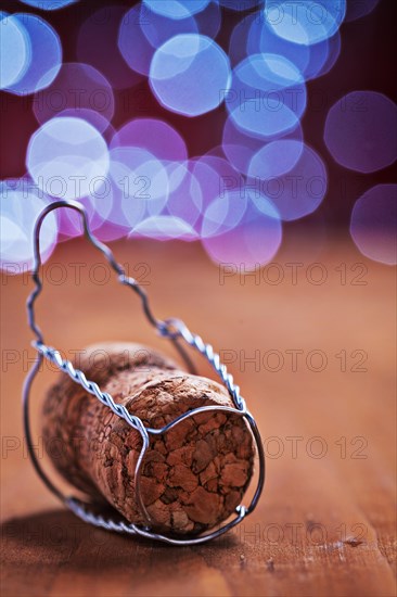 Corck for champagne on wooden table and blurred background