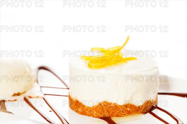 Very elegant lemon mousse dessert served whith lemon peel on top and vanilla ice cream on side