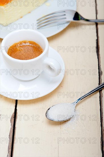 Italian espresso coffee and cheese cake over white wood table