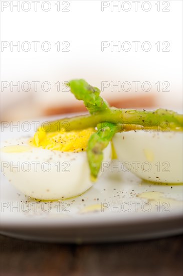 Boiled fresh green asparagus and eggs with extra virgin olive oil