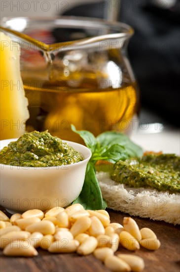 Italian basil pesto bruschetta ingredients over old wood macro