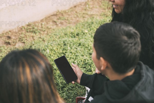 Beautiful latin family laughing from watching smartphone videos