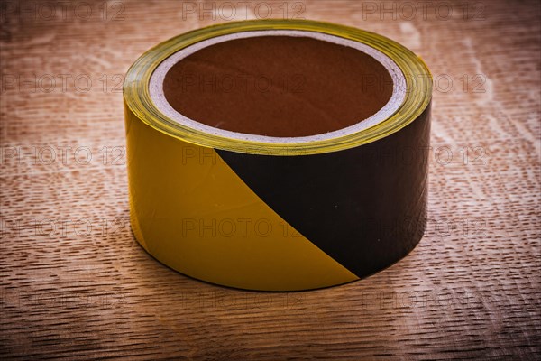 Safety tape on vintage brown wood board maintenance concept