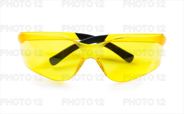 Yellow safety goggles against a white background