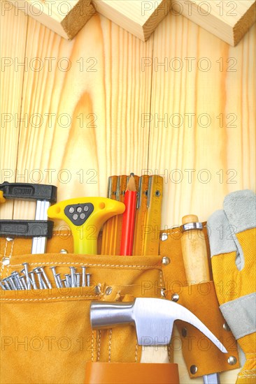 Construction tools in the belt on wooden boards