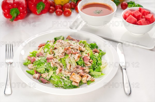 Fresh classic caesar salad served with gazpacho soup