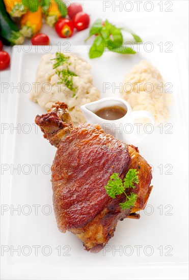 Original German BBQ pork knuckle served with mashed potatoes and sauerkraut