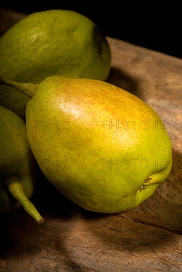 Autumn fresh pears over old wood board