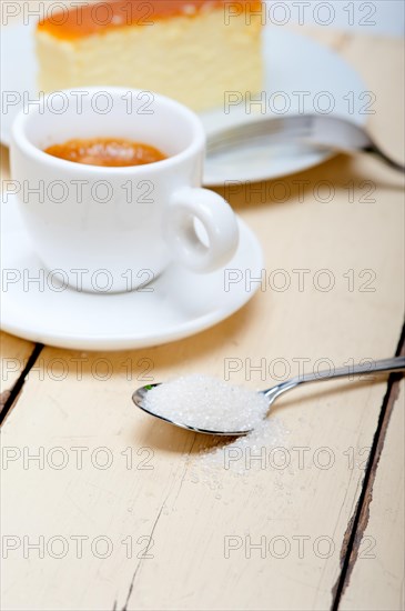 Italian espresso coffee and cheese cake over white wood table