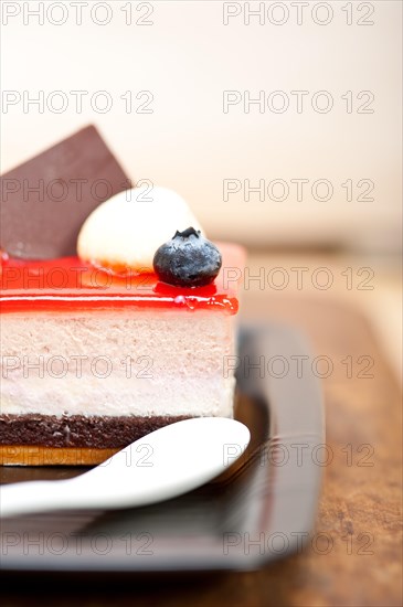 Fresh strawberry yogurt mousse with macaroon and blueberry on top