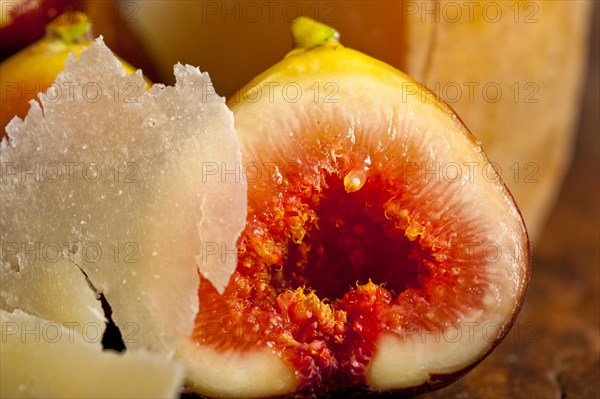 Italian pecorino cheese and fresh figs macro closeup over old wood boards