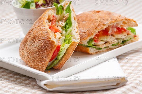 Italian ciabatta panini sandwich with chicken and tomato