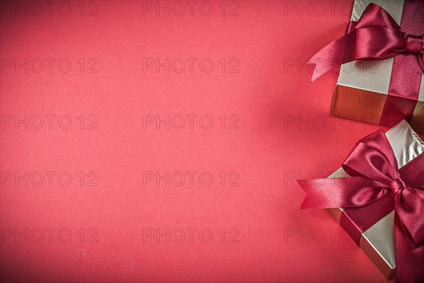 Gift boxes on red background copyspace holidays concept