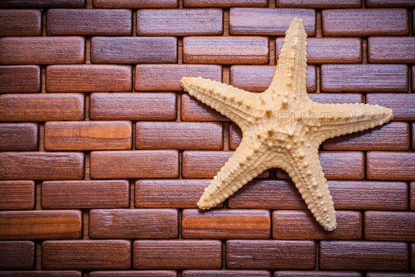 Starfish on textured wooden table mat top view image sauna concept